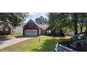 Charming single-story brick home with a well-maintained lawn, driveway and garage at 2703 Hillvale Cove Dr, Lithonia, GA 30058