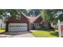 Charming single-story brick home with a well-maintained lawn, driveway and garage at 2703 Hillvale Cove Dr, Lithonia, GA 30058