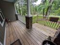 Covered front porch with stone accents and white railings, providing a perfect spot to sit and relax at 512 S Holly Springs Rd, Woodstock, GA 30188