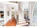 Bright foyer showcasing hardwood floors, staircase, and an open floor plan at 1558 Amberwood Creek Nw Dr, Kennesaw, GA 30152