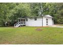 Stylish single story home with an attached garage, painted white brick, and a lush green lawn at 3042 Monterey Dr, Decatur, GA 30032