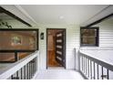 Inviting front porch with modern door, fresh paint, updated railings and large windows with dark trim at 3042 Monterey Dr, Decatur, GA 30032
