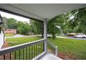 Relaxing front porch view showcasing a spacious yard, green grass, and quiet neighborhood at 3042 Monterey Dr, Decatur, GA 30032