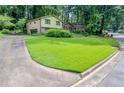 Residential house with large front lawn and a paved driveway with parking area at 3206 Pyrite Sw Cir, Atlanta, GA 30331