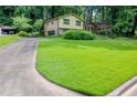 Two-story home with large front lawn, brick and siding facade and mature tree coverage at 3206 Pyrite Sw Cir, Atlanta, GA 30331
