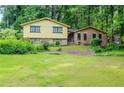 Two-story house with a well-maintained lawn and greenery in front at 3206 Pyrite Sw Cir, Atlanta, GA 30331