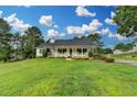 Single-story home with large yard, well-maintained landscaping, and inviting front porch at 3265 Bold Springs Rd, Dacula, GA 30019