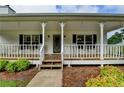 Welcoming front porch featuring rocking chairs, offering a relaxing outdoor space for enjoying the neighborhood at 3265 Bold Springs Rd, Dacula, GA 30019