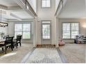 Inviting entryway featuring neutral tones, hardwood floors, a decorative rug, and plenty of natural light at 4590 Sierra Creek Dr, Hoschton, GA 30548