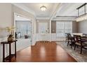 Elegant foyer with hardwood floors, wainscoting, and an open view to a dining room and office at 506 Spring View Dr, Woodstock, GA 30188