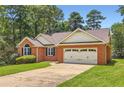 Charming brick home with a well-manicured lawn and attached two car garage at 11473 Summer Creek Dr, Hampton, GA 30228