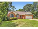 Charming brick home with a well-manicured lawn and attached two car garage at 11473 Summer Creek Dr, Hampton, GA 30228