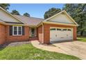 Charming brick home with a well-manicured lawn and attached two car garage at 11473 Summer Creek Dr, Hampton, GA 30228