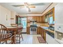 Cozy kitchen featuring wood cabinetry, stainless steel appliances, and a charming dining area at 480 Pineburr Ln, Stone Mountain, GA 30087