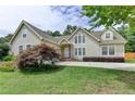 Inviting two-story home showcasing a lush green lawn, mature trees, and a serene setting at 525 Hunnicutt Se Rd, Mableton, GA 30126