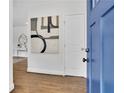 Bright entryway featuring hardwood floors, a blue front door, and stylish decor setting a welcoming tone at 2222 Beecher Sw Cir, Atlanta, GA 30311