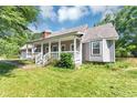 Charming single-story home with a covered porch on a well-maintained lawn at 6744 Rockbridge Rd, Stone Mountain, GA 30087