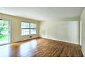 Bright living room featuring hardwood floors, large window, and neutral wall color at 2543 Asbury Court Ct, Decatur, GA 30033
