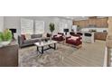 Open-concept living room with an eat-in kitchen, stylish decor, and plenty of natural light at 2766 Aralynn Way, College Park, GA 30337