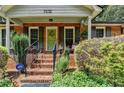 Inviting front porch with brick steps, dark shutters and lovely landscaping at 3232 Valaire Drive Dr, Decatur, GA 30033