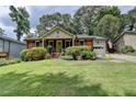 Charming red brick home featuring a lush front yard and well-manicured landscaping at 3232 Valaire Drive Dr, Decatur, GA 30033