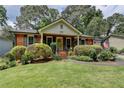 Charming red brick home featuring a lush front yard and well-manicured landscaping at 3232 Valaire Drive Dr, Decatur, GA 30033
