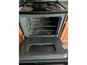 Close-up of oven interior with metal racks, showcasing the cleanliness and functionality at 8430 Carlington Ln, Jonesboro, GA 30236