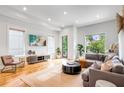 Sun-filled living room with hardwood floors, recessed lighting, stylish furniture, and large windows offering tree views at 167 Sampson Ne St, Atlanta, GA 30312