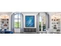 Bright living room with arched windows, built-in shelves, and stylish decor at 3286 Northside Nw Pkwy # Ph2, Atlanta, GA 30327
