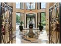 Grand building lobby with detailed tile floor, statement table, and decorative ironwork at 3286 Northside Nw Pkwy # Ph2, Atlanta, GA 30327