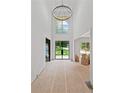 Grand foyer with soaring ceilings, a modern chandelier, and a double-door entry at 4125 Ashwoody Ne Trl, Brookhaven, GA 30319