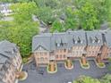 Aerial view of townhomes displaying roof lines, landscaping, and driveway parking at 4222 Rickenbacker Ne Dr # 9, Atlanta, GA 30342