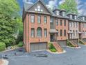 Charming townhome featuring brick facade, private garage, and inviting front steps at 4222 Rickenbacker Ne Dr # 9, Atlanta, GA 30342
