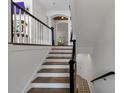 Staircase with wooden steps, white risers, and a black railing with white balusters at 4222 Rickenbacker Ne Dr # 9, Atlanta, GA 30342
