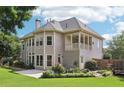 Spacious backyard featuring a covered porch, lush greenery, and a well-maintained lawn for outdoor enjoyment at 4620 Springdale Ct, Cumming, GA 30041