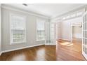 Well-lit office featuring hardwood floors, a window with blinds, and an open doorway to the foyer at 4620 Springdale Ct, Cumming, GA 30041