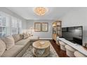 Bright living room with neutral tones, hardwood floors, and stylish furniture at 2 Arpege Nw Way, Atlanta, GA 30327