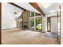 Bright living room boasts a stone fireplace, vaulted ceiling, and large windows offering scenic views at 3323 Silver Ridge Ct, Duluth, GA 30096