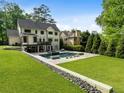 Expansive backyard with an inviting pool, lush lawn and stone accents perfect for outdoor enjoyment at 4225 Wieuca Ne Rd, Atlanta, GA 30342