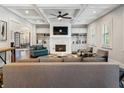Bright living room with coffered ceilings, a marble fireplace, and built-in shelving for a cozy yet elegant feel at 4225 Wieuca Ne Rd, Atlanta, GA 30342