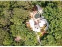 Aerial view showcasing a secluded home surrounded by lush, mature trees, offering privacy and tranquility at 4850 Lake Fjord Pass, Marietta, GA 30068