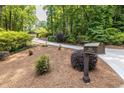 Long driveway leading to a private home, nestled among mature trees and lush landscaping at 4850 Lake Fjord Pass, Marietta, GA 30068