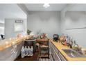 Features a countertop, sink, storage, and decorative lighting that enhances the bar's ambiance at 2935 Sawgrass Sw Trl, Lilburn, GA 30047