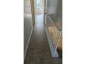 Hallway with a railing and door at the end at 437 Saint Ives Sq, Stone Mountain, GA 30083