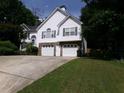 Charming two-story home with white siding, stone accents, two-car garage, and a well-maintained front yard at 49 Brinkley Ct, Dallas, GA 30157