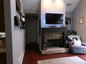 Cozy living room features a stone fireplace, mounted television, and comfortable seating at 49 Brinkley Ct, Dallas, GA 30157