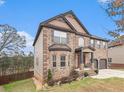 Attractive brick residence boasting a two-car garage, covered entry, and lush green surroundings at 949 Nevis Way, Mcdonough, GA 30253