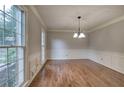 Formal dining room with wainscoting, hardwood floors, and ample natural light at 425 Bellflower Ct, Roswell, GA 30076