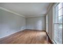 Bright living room featuring hardwood floors, neutral paint, and large windows at 425 Bellflower Ct, Roswell, GA 30076
