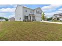 Two-story home with a large garage, light gray siding and black shutters at 600 Tudor St, Kingston, GA 30145